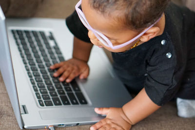 Baby playing with laptop computer 