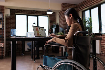 Businesswoman using laptop at office