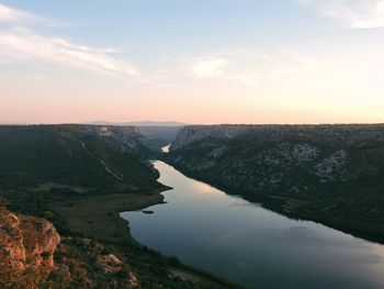 Scenic view of lake against sky at sunset