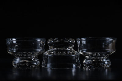 Close-up of glass bowls against black background