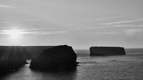 Rocks on sea against sky