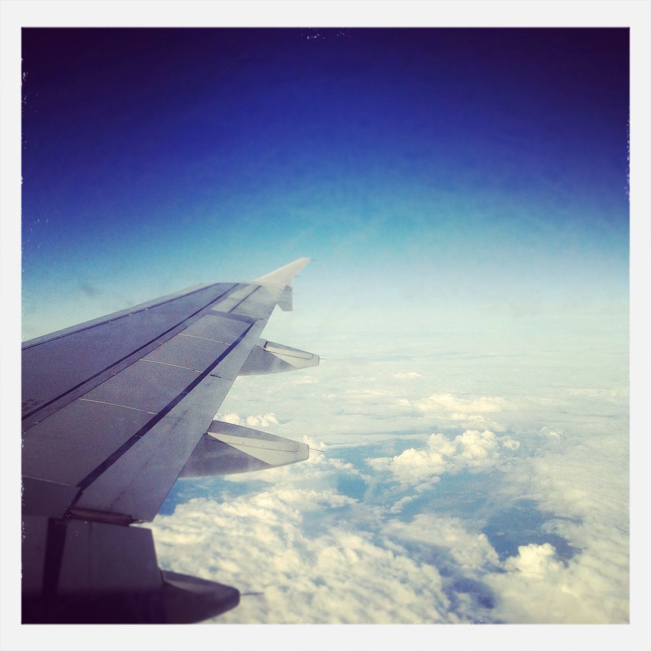 airplane, transportation, air vehicle, aircraft wing, flying, mode of transport, transfer print, part of, cropped, sky, aerial view, auto post production filter, journey, travel, scenics, blue, beauty in nature, mid-air, nature, airplane wing