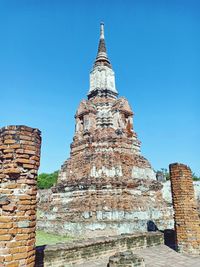 Low angle view of old building against blue sky