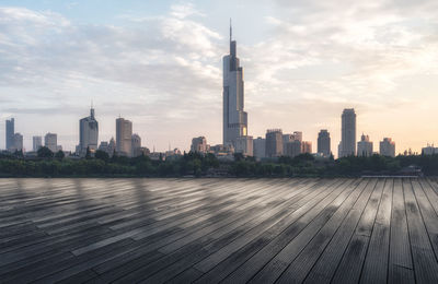 Buildings in city against cloudy sky