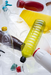 High angle view of multi colored bottles on table