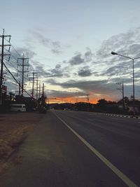 Street against sky during sunset