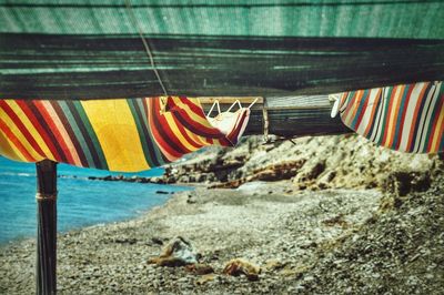 Close-up of multi colored umbrellas on beach