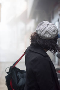 Rear view of woman with umbrella on street