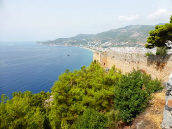 High angle view of sea and mountains against sky