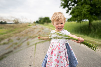 Girl standing against plants