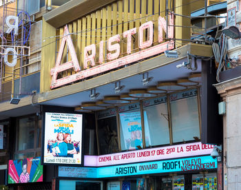 Low angle view of information sign on store