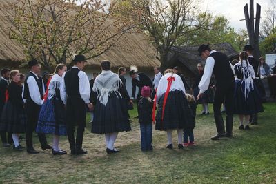 Rear view of people standing in park