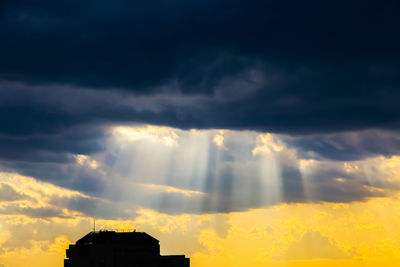 Low angle view of dramatic sky during sunset