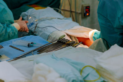 Midsection of man using mobile phone on bed