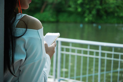 Midsection of woman using mobile phone