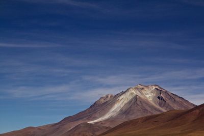 Scenic view of mountains against cloudy sky