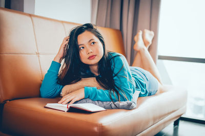 Portrait of woman sitting at home