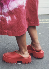 Low section of woman standing on street