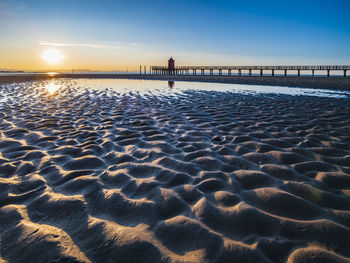 Scenic view of beach against sky during sunset