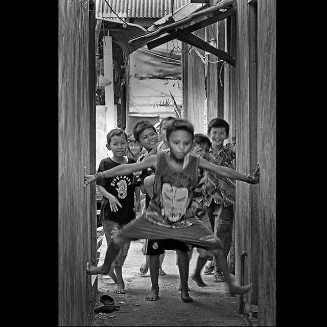 indoors, wood - material, domestic animals, standing, front view, door, animal themes, men, wooden, lifestyles, home interior, togetherness, day, childhood, full length, dog, built structure, mammal, house