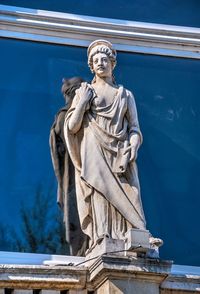 Low angle view of statue against blue sky