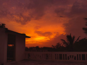 Silhouette buildings against sky during sunset