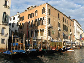 Boats in river with buildings in background