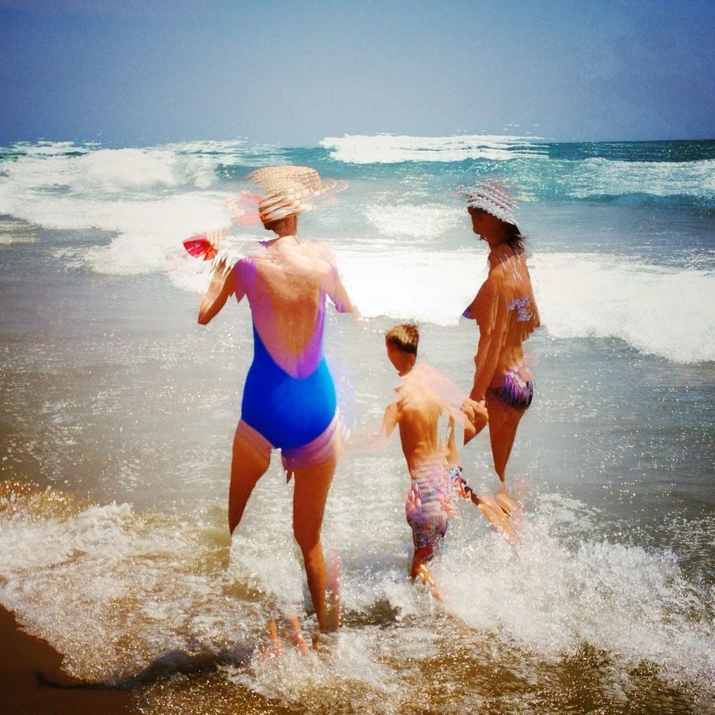 water, sea, beach, horizon over water, leisure activity, shore, lifestyles, full length, vacations, sand, standing, wave, togetherness, rear view, clear sky, blue, domestic animals, walking