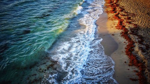 High angle view of waves on beach against sky