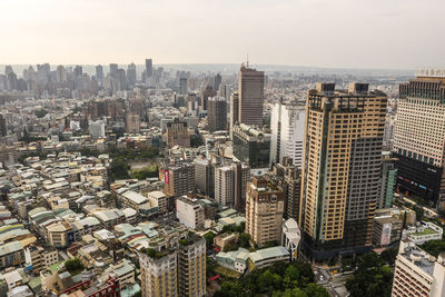 High angle view of modern buildings in city against sky