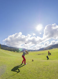 Italy, veneto, dolomites, senior couple on golf course