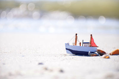 Toy boat on beach