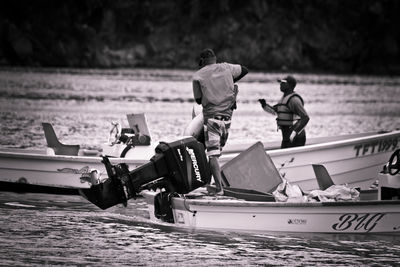 People on boat at shore