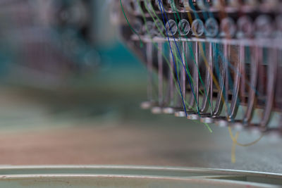 Close-up of colorful threads in sewing machine