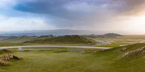 Scenic view of mountains against cloudy sky