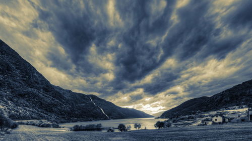 Scenic view of mountains against cloudy sky