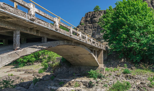 Low angle view of bridge over river against sky