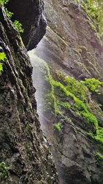 Low angle view of waterfall amidst rocks