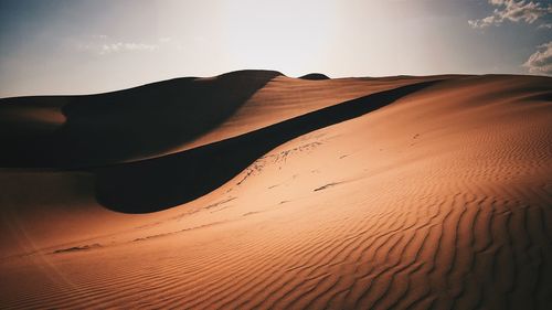 Scenic view of desert against sky during sunset