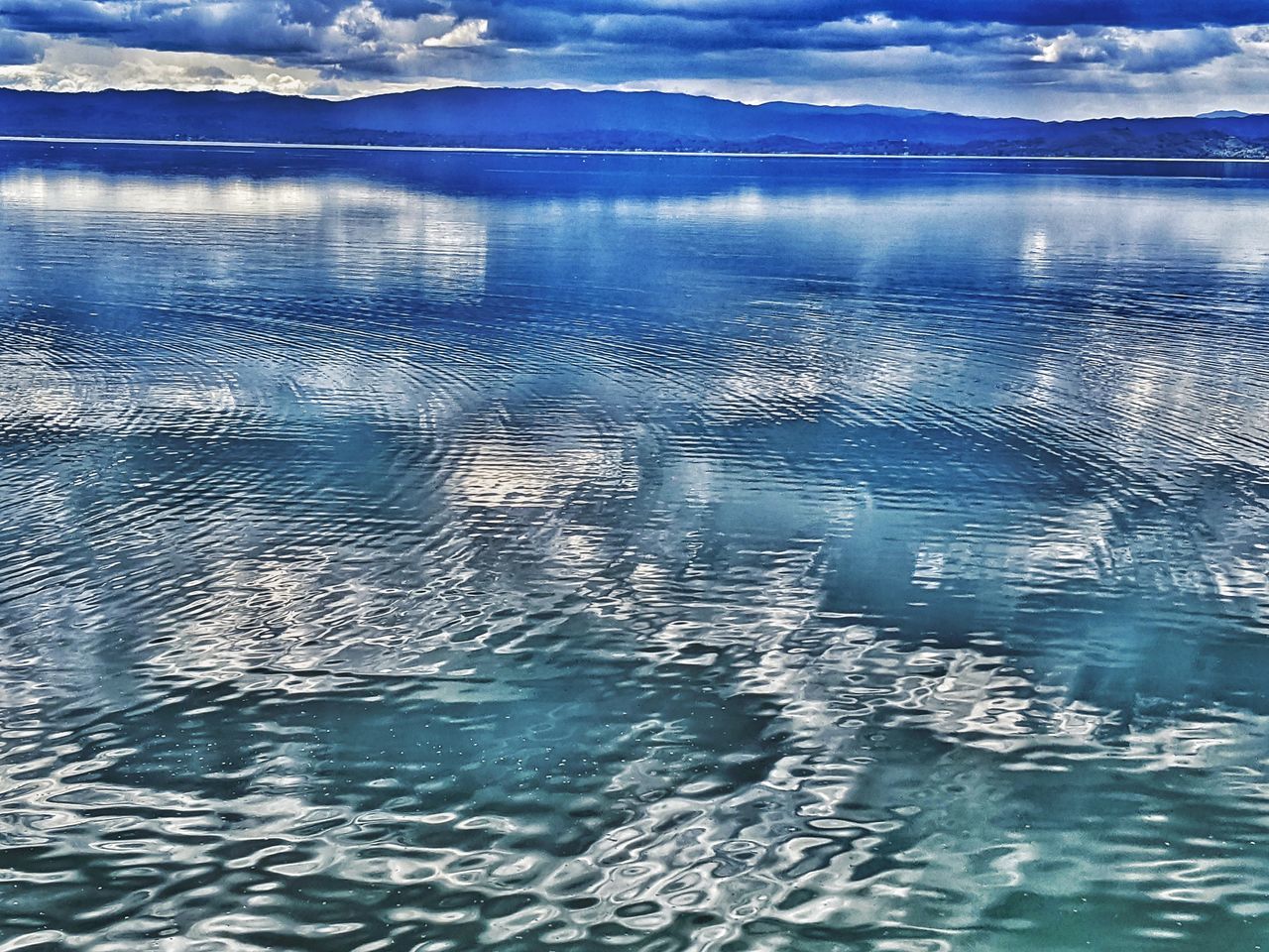 REFLECTION OF SKY IN SWIMMING POOL