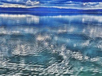 Swimming pool by sea against sky