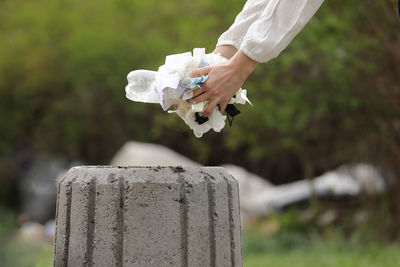 Cropped hand of woman holding flower