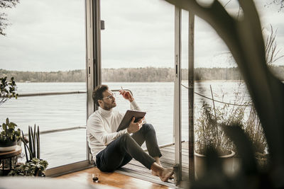 Thoughtful businessman working at houseboat