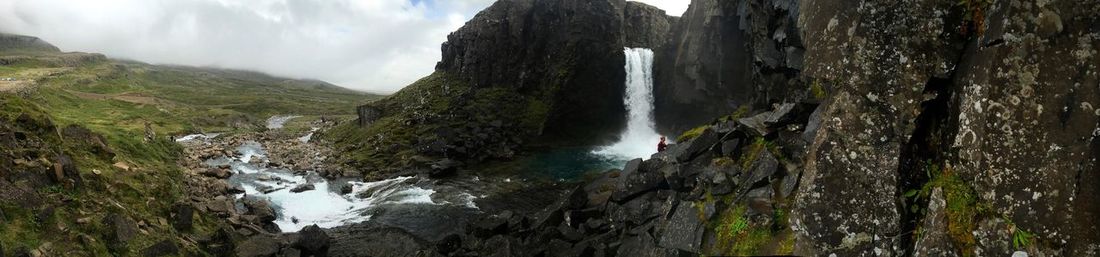 Panoramic view of waterfall against sky