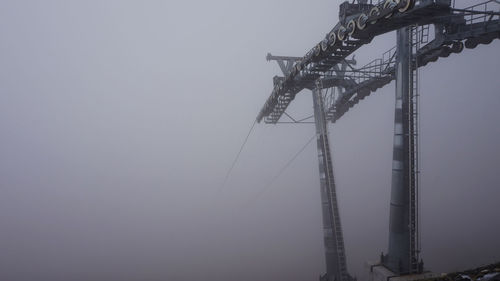 Low angle view of crane against clear sky