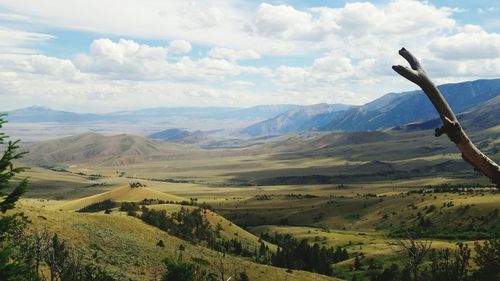 Scenic view of mountains against cloudy sky