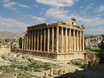 Ruins of building against cloudy sky