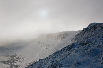 Scenic view of mountains against sky during winter