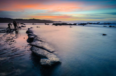 Scenic view of sea against sky at sunset