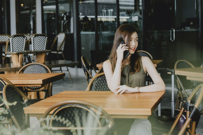 Woman sitting on chair at table